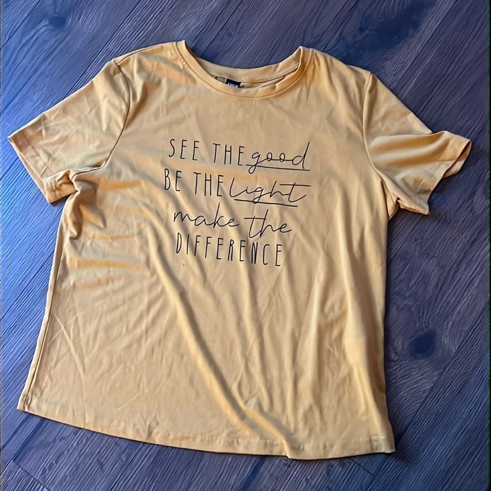 size large yellow t shirt with word graphic